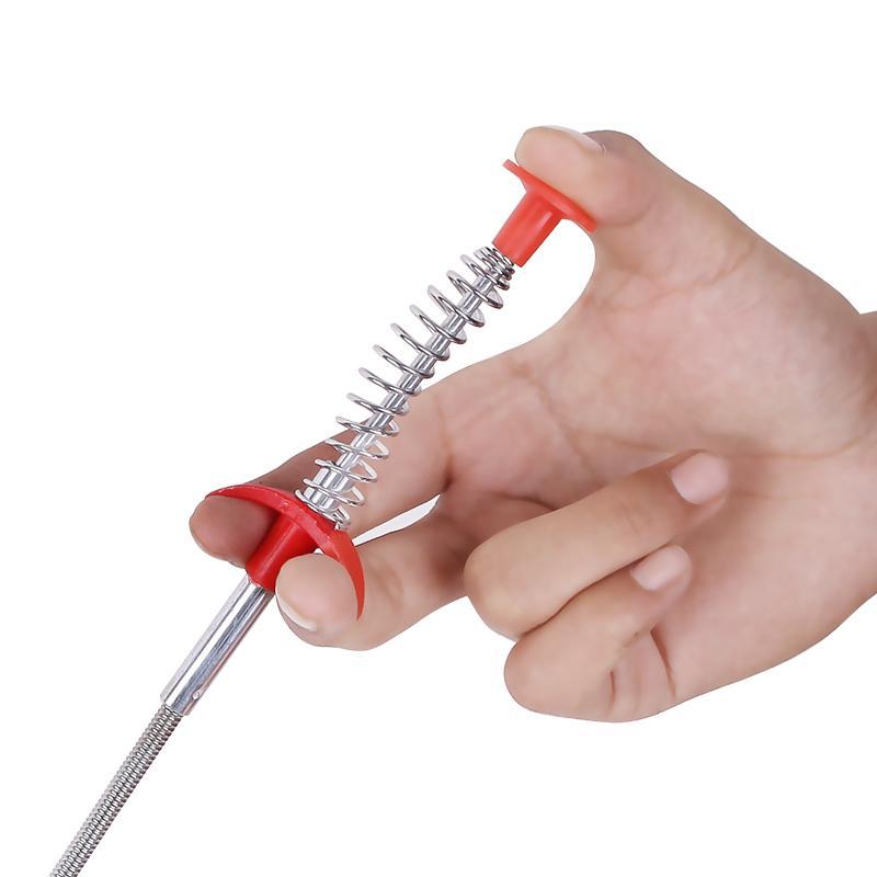 Person demonstrating use of 60cm clog remover tool in a kitchen sink drain