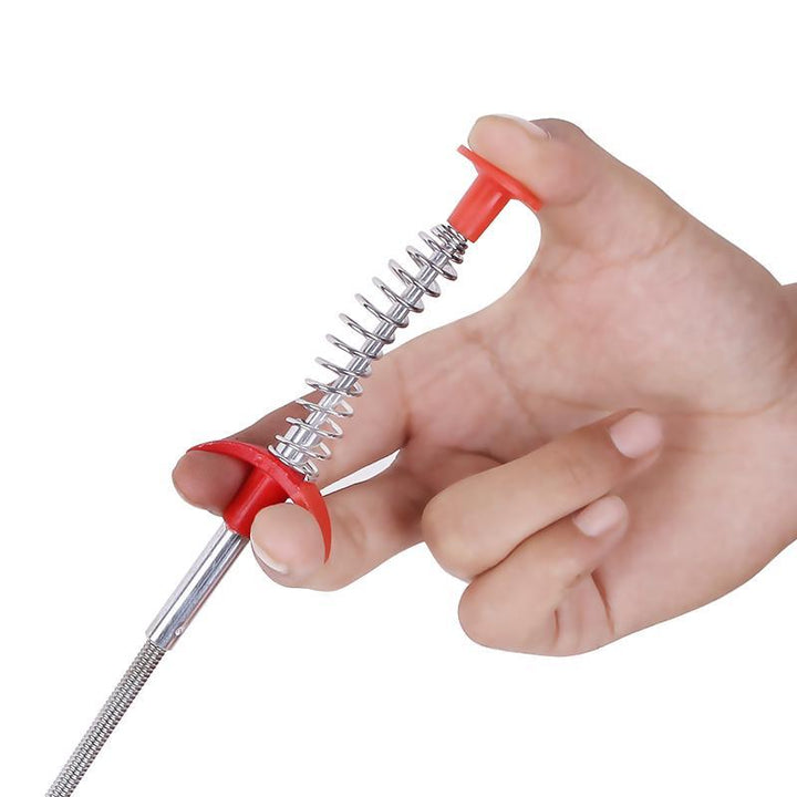 Person demonstrating use of 60cm clog remover tool in a kitchen sink drain