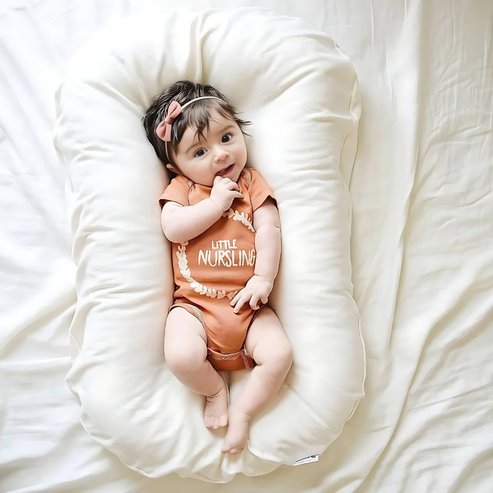 Ergonomic Breathable Baby Pillow in pink, green, and brown; hypoallergenic, provides head support, prevents flat head.
