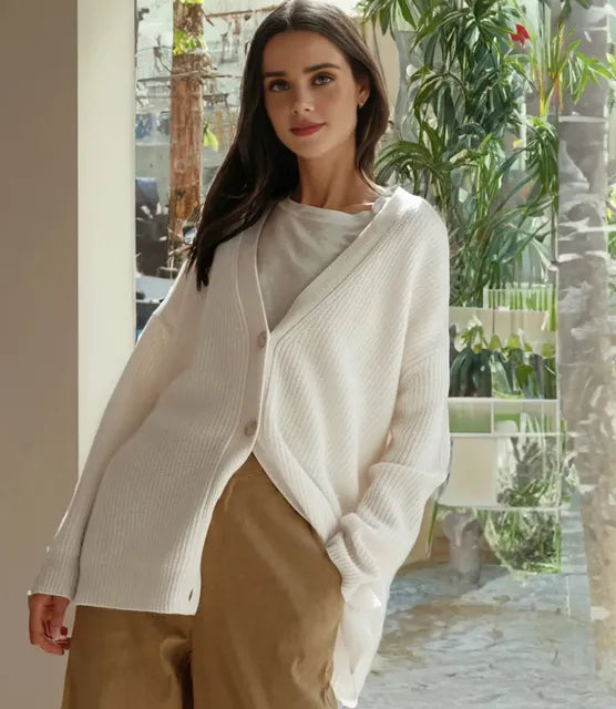 Front view of a soft, stylish women's cashmere cardigan in beige, showcasing its elegant, timeless silhouette for layering.