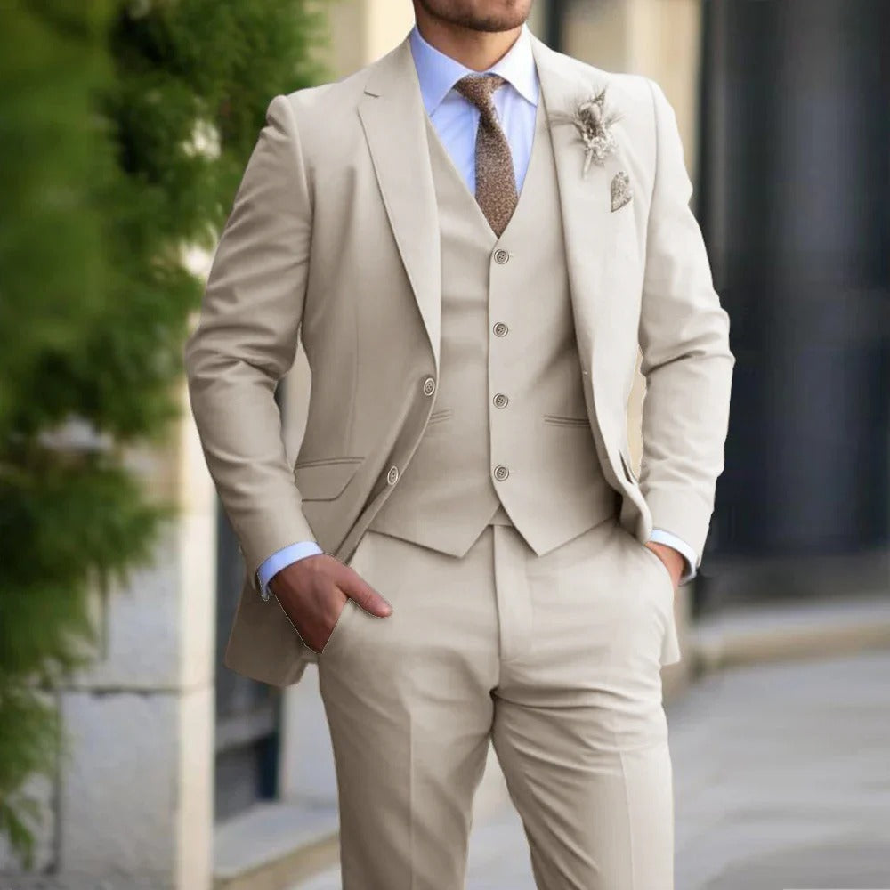 "Men's slim fit 3-piece suit in beige on mannequin; sleek blazer, vest, trousers; perfect for formal events; versatile attire