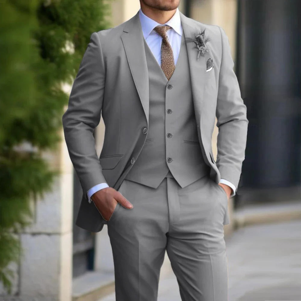 "Men's slim fit 3-piece suit in beige on mannequin; sleek blazer, vest, trousers; perfect for formal events; versatile attire