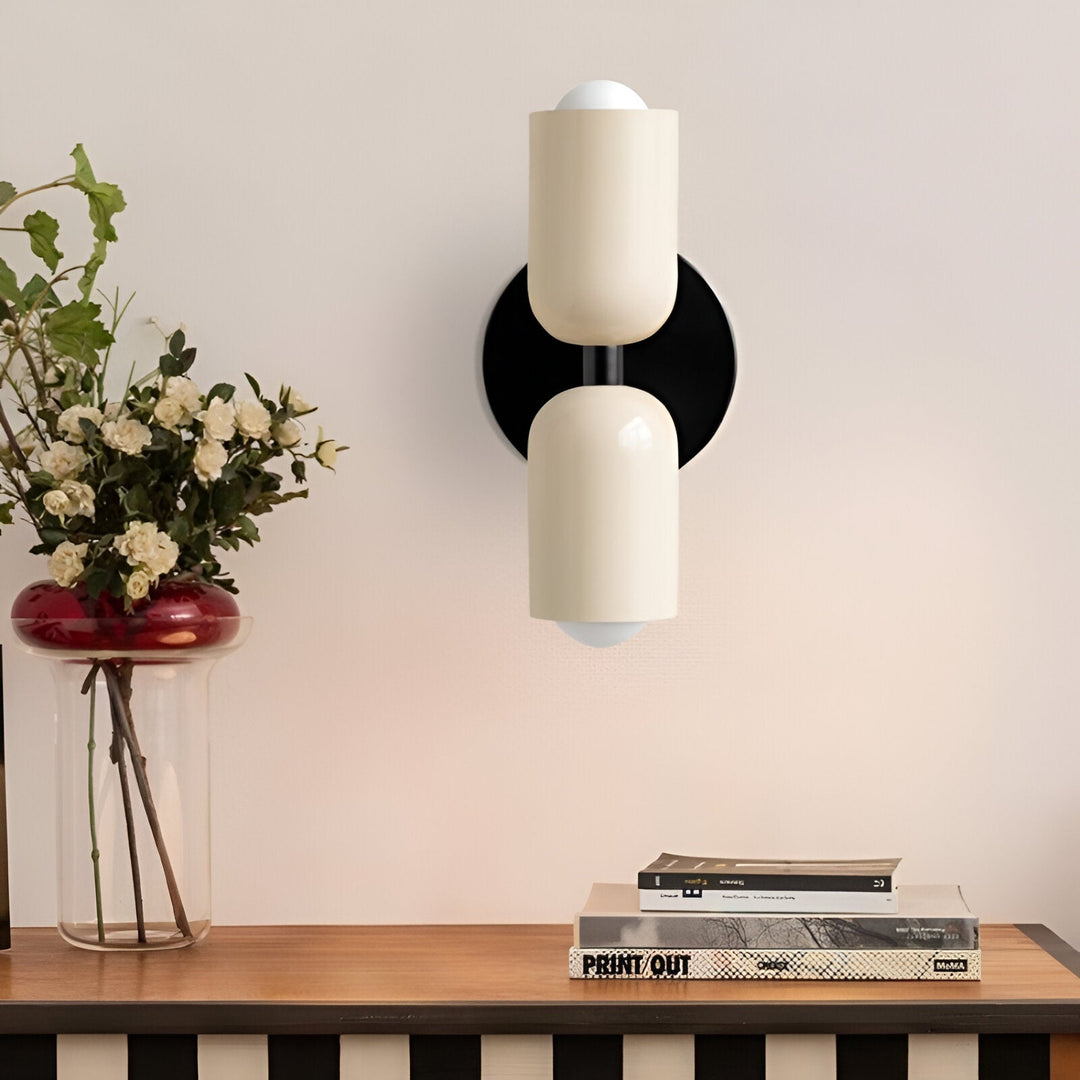 Nordic colourful double head wall light in vibrant colors, painted iron, sleek cylindrical design, casts light up and down.
