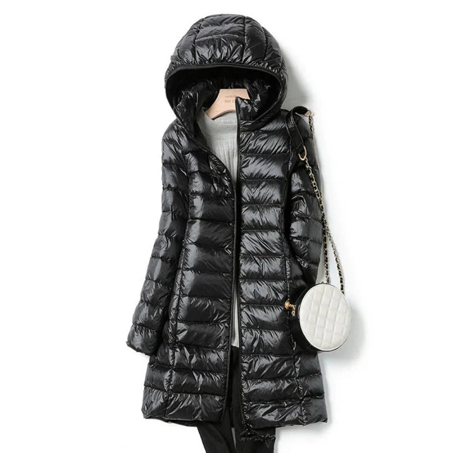 "Stylish women's long hooded puffer jacket with quilted design and extended length for warmth and protection in winter."
