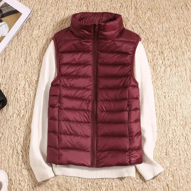 "Ultra-light women's autumn down vest in sleek fit, available in Black, Blue, Khaki; stylish and packable for cool days."