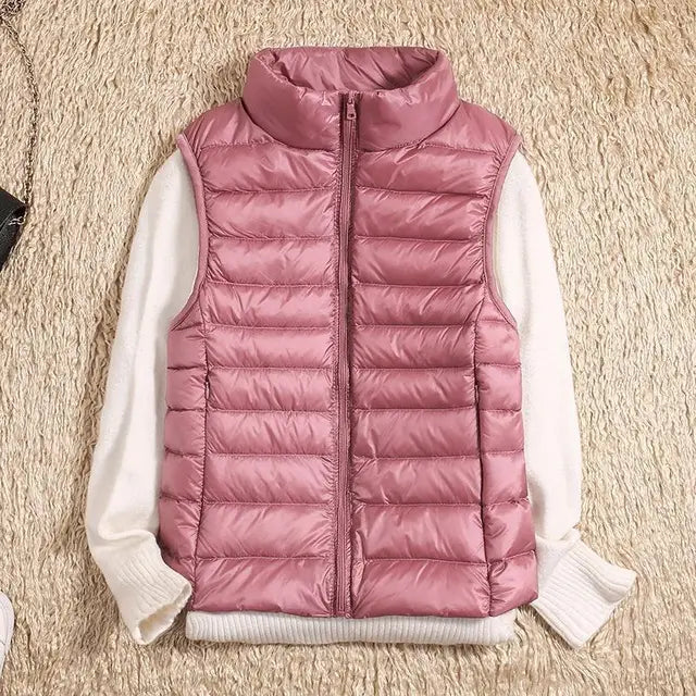 "Ultra-light women's autumn down vest in sleek fit, available in Black, Blue, Khaki; stylish and packable for cool days."