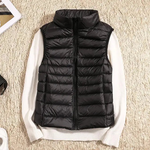 "Ultra-light women's autumn down vest in sleek fit, available in Black, Blue, Khaki; stylish and packable for cool days."