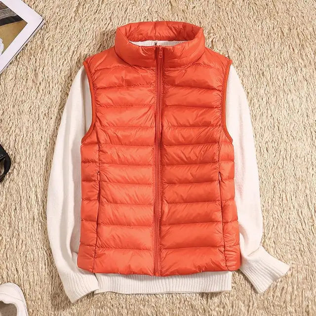 "Ultra-light women's autumn down vest in sleek fit, available in Black, Blue, Khaki; stylish and packable for cool days."