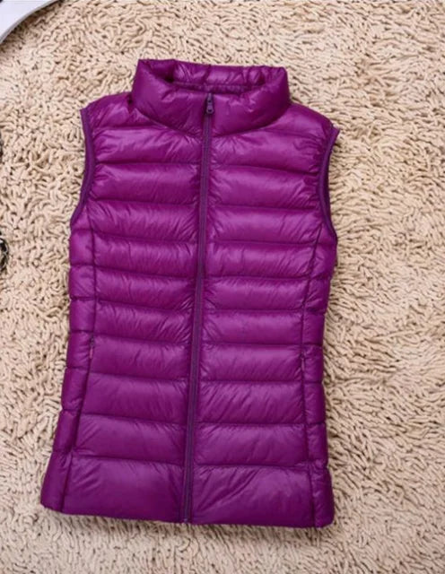 "Ultra-light women's autumn down vest in sleek fit, available in Black, Blue, Khaki; stylish and packable for cool days."