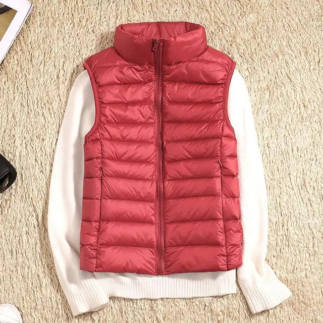 "Ultra-light women's autumn down vest in sleek fit, available in Black, Blue, Khaki; stylish and packable for cool days."