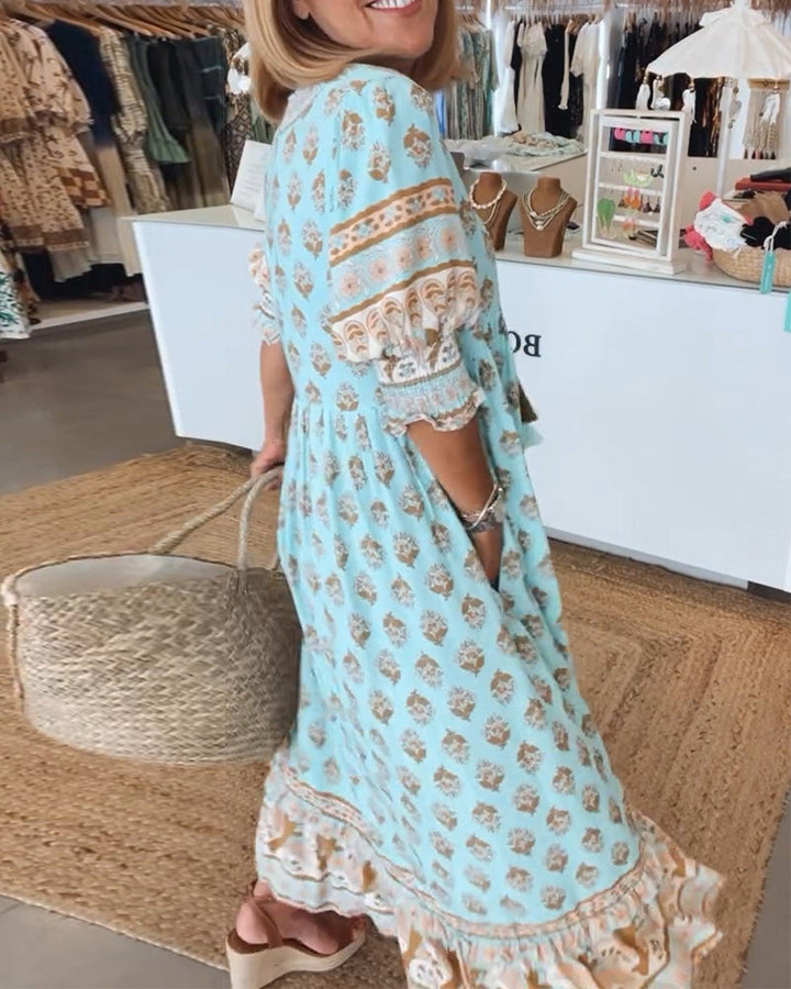 Women's V-Neck Half-Sleeve Dress with bold print, vibrant colors; casual or evening wear, enhances elegance and comfort.