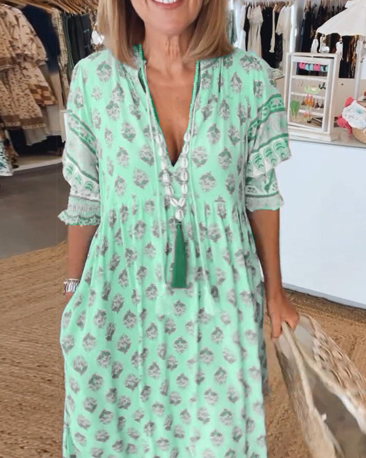Women's V-Neck Half-Sleeve Dress with bold print, vibrant colors; casual or evening wear, enhances elegance and comfort.