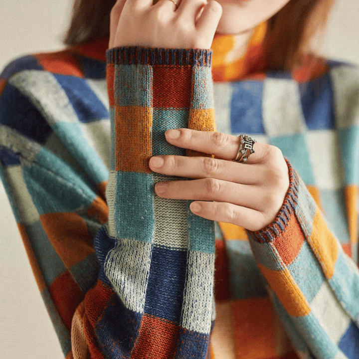 Women's cashmere patchwork turtleneck sweater in mélange hues, showcasing a unique, cozy, and stylish design for winter.