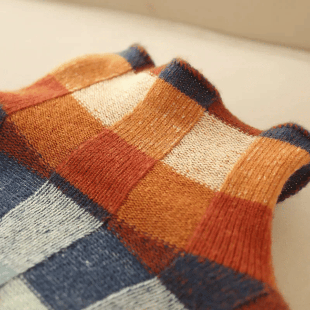 Women's cashmere patchwork turtleneck sweater in mélange hues, showcasing a unique, cozy, and stylish design for winter.