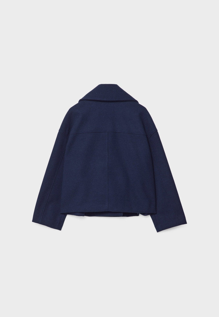 Women's double-breasted cropped jacket, front view featuring sharp lapels, structured design, and chic oversized buttons.