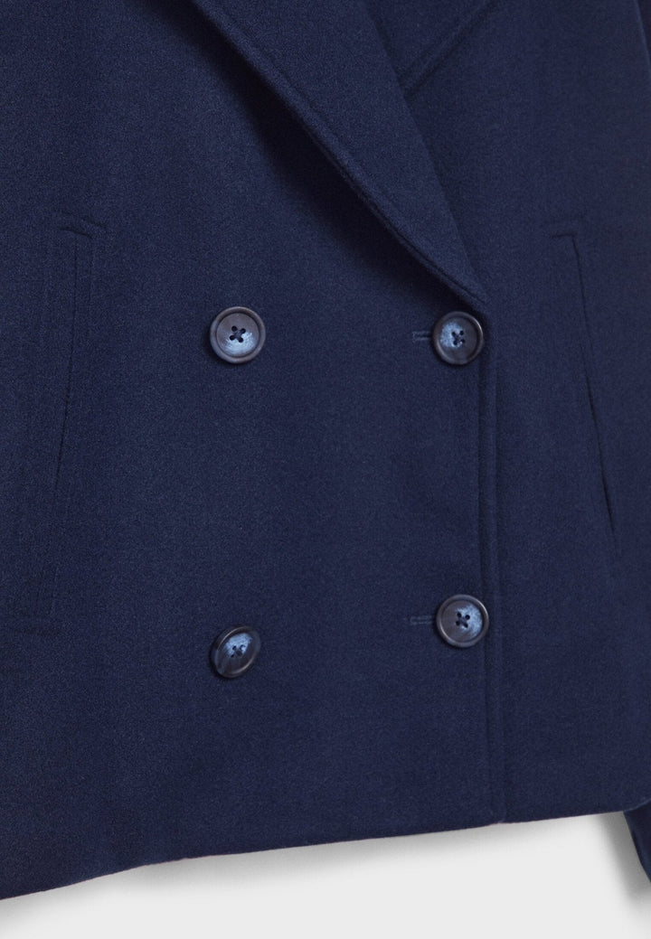 Women's double-breasted cropped jacket, front view featuring sharp lapels, structured design, and chic oversized buttons.