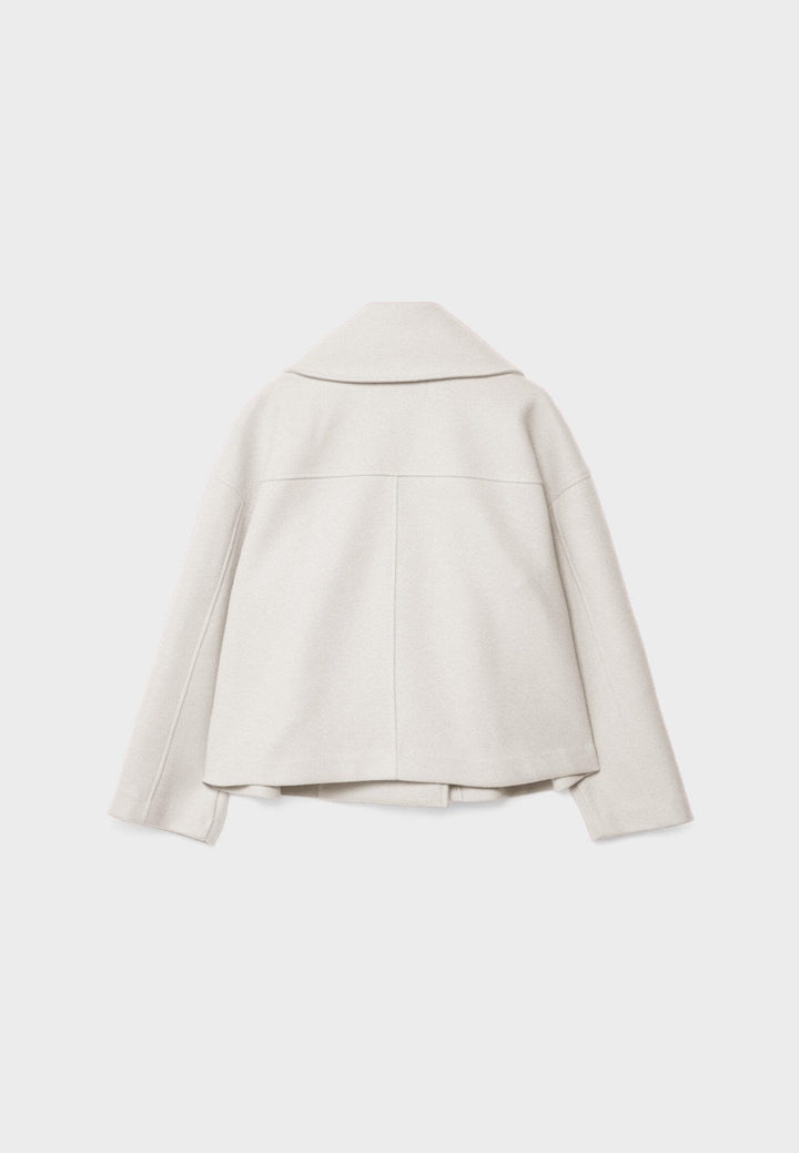 Women's double-breasted cropped jacket, front view featuring sharp lapels, structured design, and chic oversized buttons.