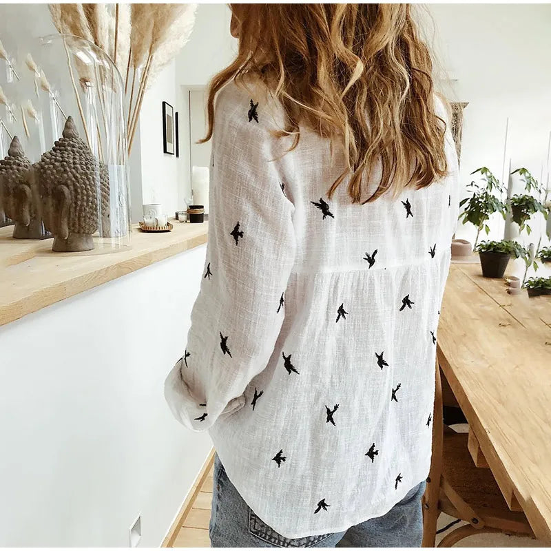 "Women's relaxed bird-print button-up blouse with colorful bird patterns, flowy silhouette, perfect for casual or office wear