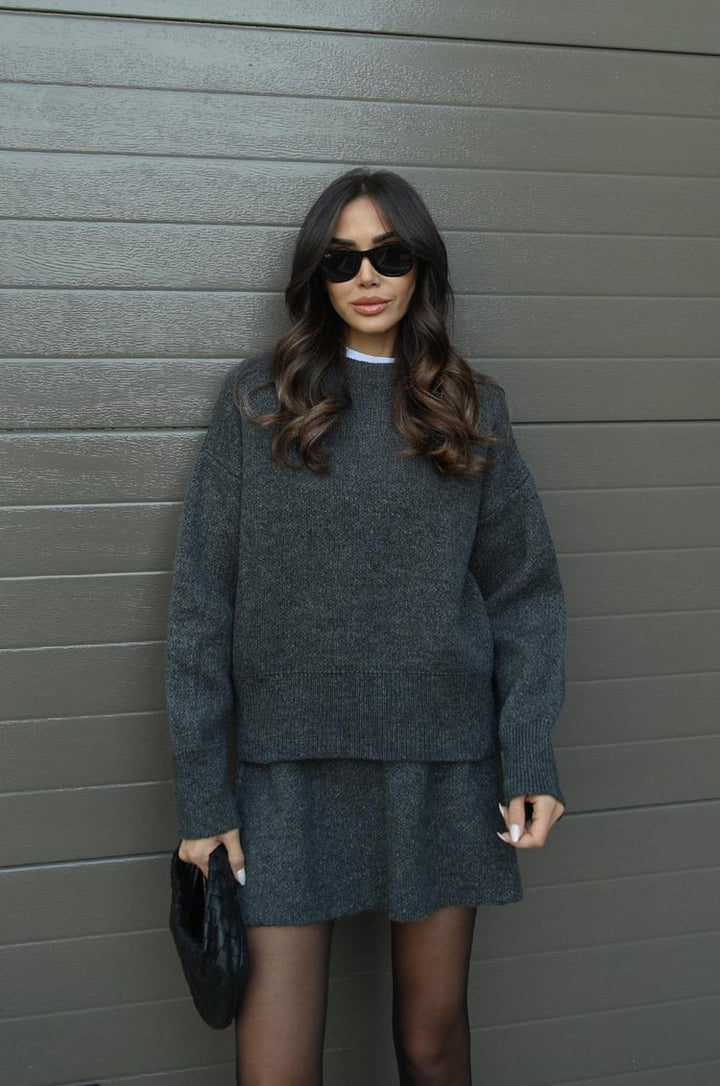 Casual women's sweater and mini skirt set in a soft knit fabric, ideal for everyday wear.