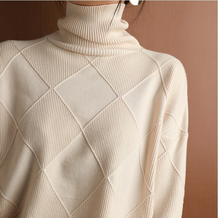 Women's oversized ribbed knit sweater draped over a chair, highlighting coziness