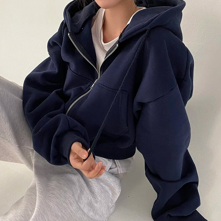 Close-up of the soft fabric on a women's cropped zip-up hoodie, great for cozy winter outfits.