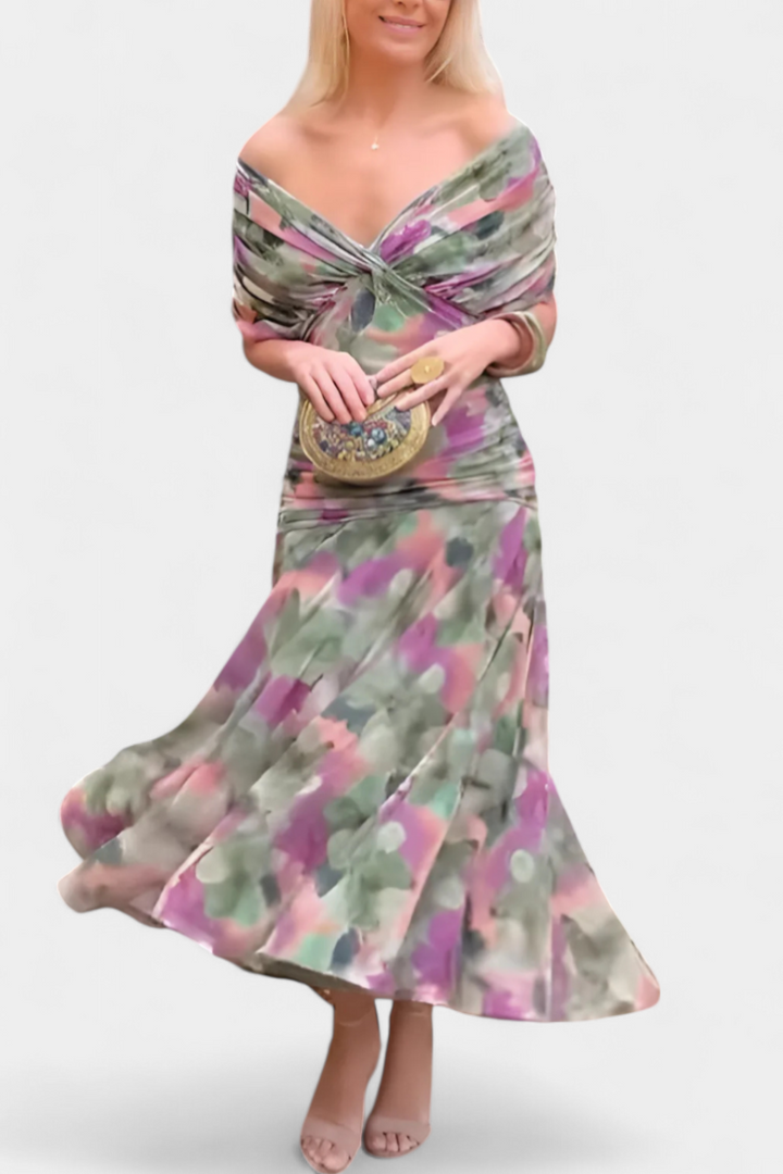 Elegant women's maxi dress showcasing a vibrant floral print and flattering pleated waist detail.