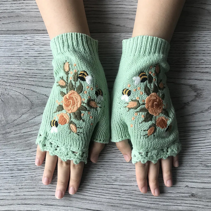 Fashionable women's winter gloves, embroidered detailing on a soft black acrylic fabric, cozy and chic.