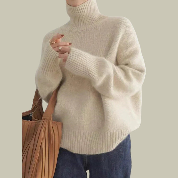 Women's long sleeve gray merino wool sweater, high neck and relaxed fit for comfort.
