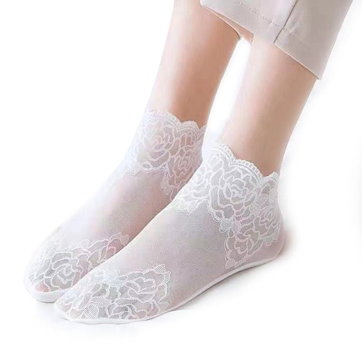 Close-up of the stretchable cuff on an elegant lace mesh ankle sock, ensuring a snug fit.