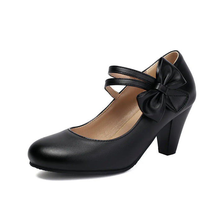 Comfortable women's pink block heel pumps with a charming bow, perfect as party heels.