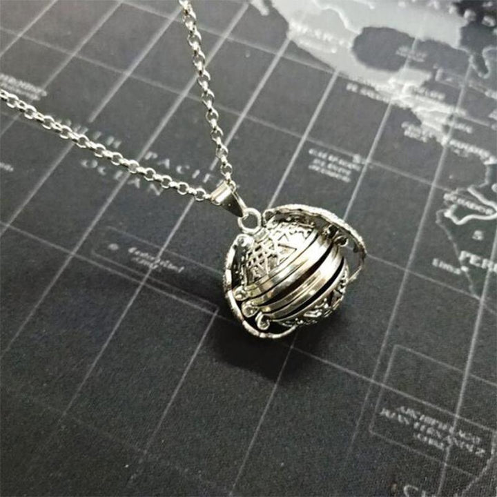 Women's silver-tone angel wing locket, intricately designed, opens to reveal cherished photos.