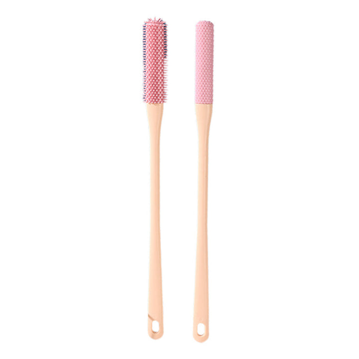 The anti-itch brush demonstrating its size, fitting comfortably in the palm of a hand