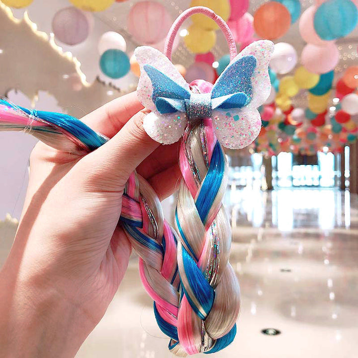 Close-up of a girl's head with an attached colorful braided hair extension, showing how it looks