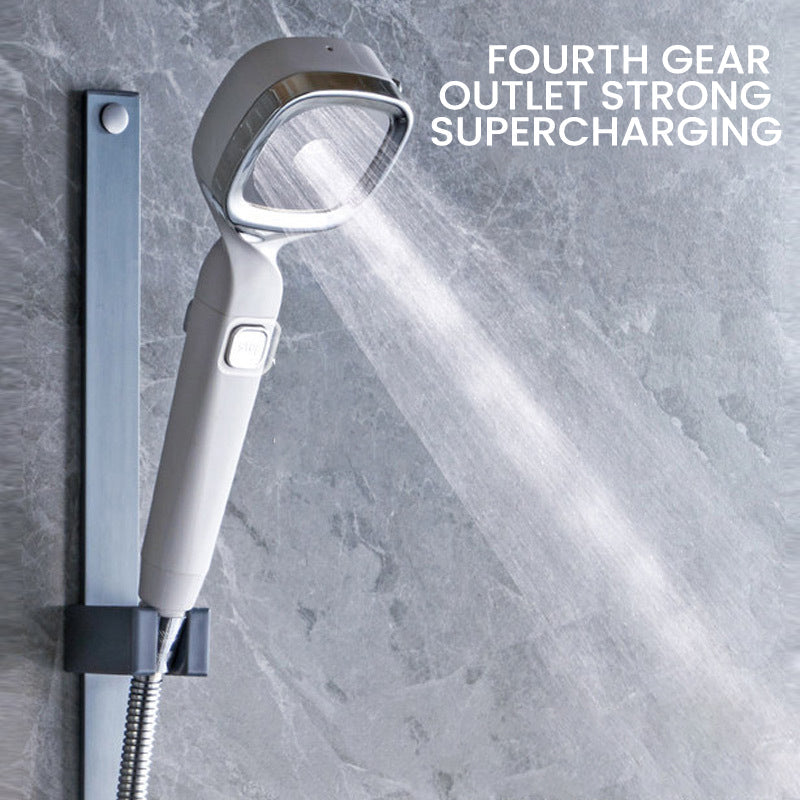 Detail view of the pause switch on a universal handheld pressurized shower head, ensuring water efficiency.
