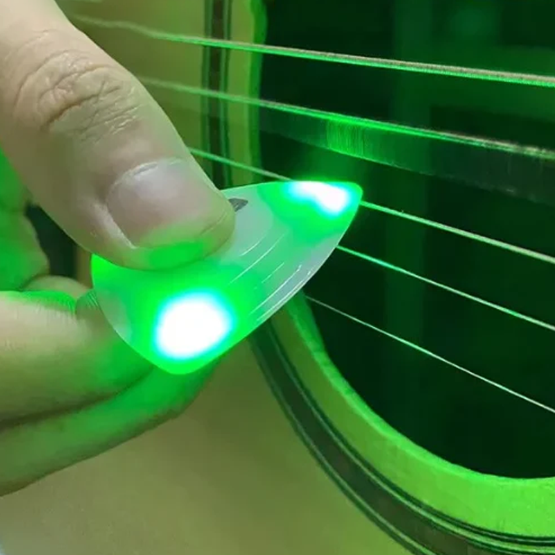 Guitarist using a Light Up Guitar Pick during a live performance, creating an engaging visual effect.