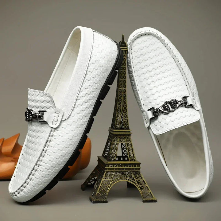 Side view of a black men's grip loafer, showcasing the classic dress shoe design