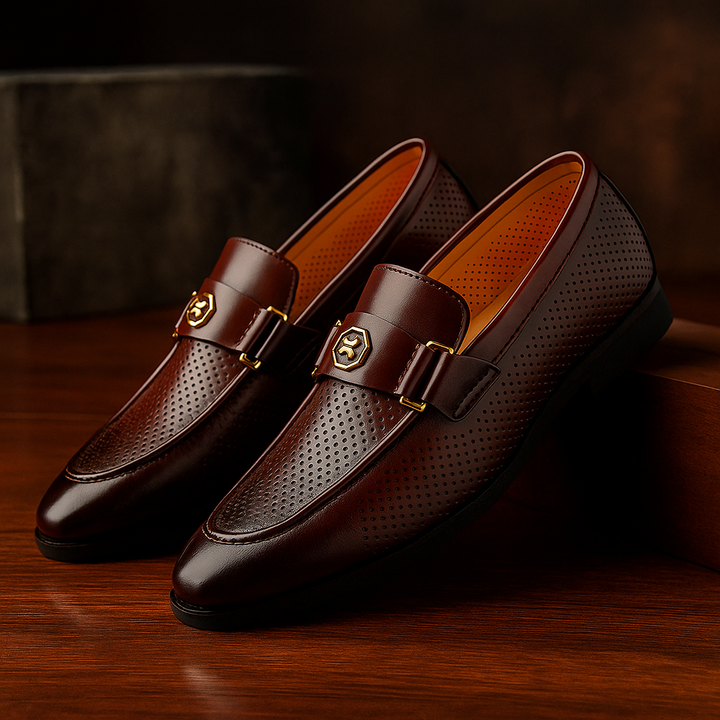 Men's black perforated leather slip-on loafers, ideal for breathable and comfortable business casual style.