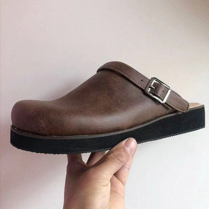 High-angle view of men's luxury leather clogs, emphasizing their sleek and sophisticated look.
