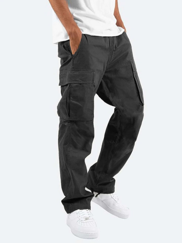 Men's relaxed fit cargo pants in a neutral color, showcasing side pockets for utility and casual wear.