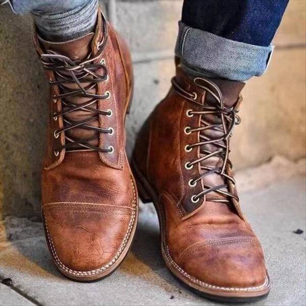 Close-up of durable men's black leather lace-up winter boots for cold weather outdoor adventures