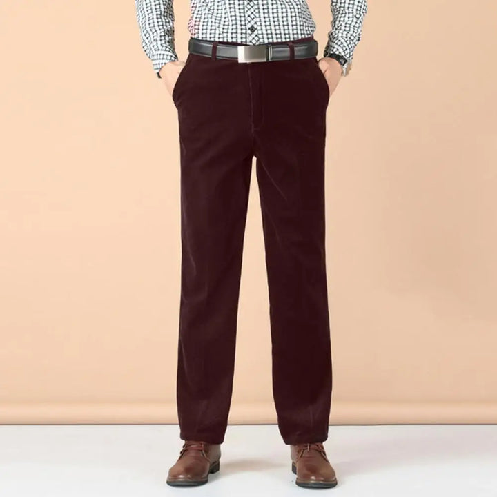 Close-up of the rich texture of men's forest green velvet trousers, emphasizing luxury and tailored fit.