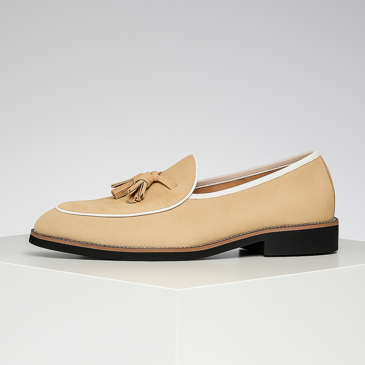 Close-up of a men's brown suede tassel loafer, highlighting the luxurious texture and detailing.