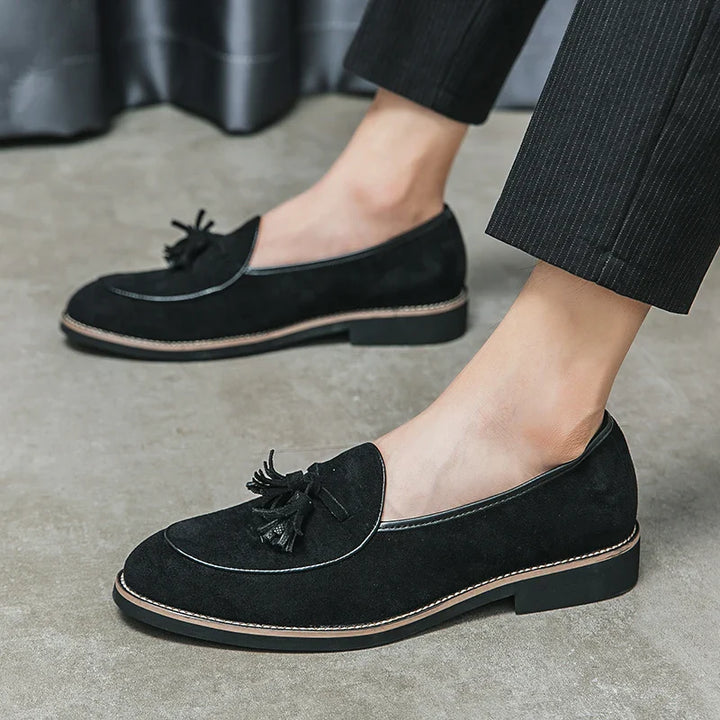 Side profile of a men's suede tassel loafer, demonstrating the sleek fit and comfortable design.