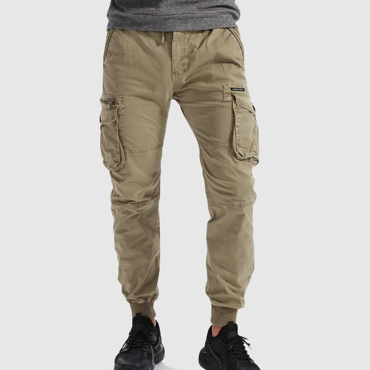 Men's versatile cargo jogger pants in black, showing elastic waist and cuffed ankles for comfort.