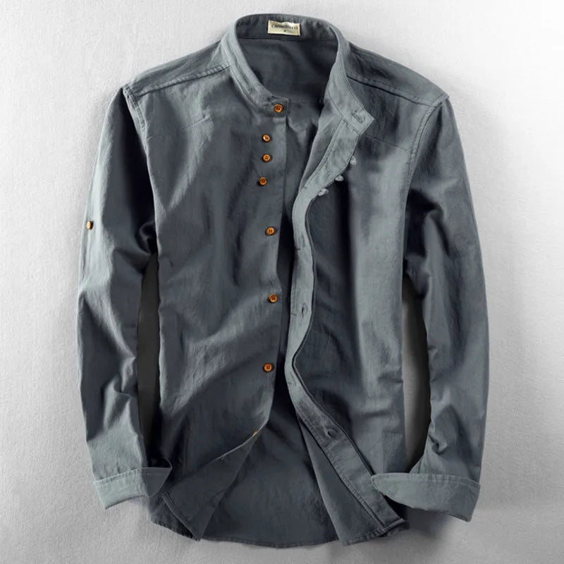 Man's arm wearing a white cotton-linen long sleeve band collar shirt, comfortable fit