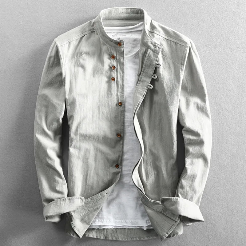 Stack of folded men's white cotton-linen band collar shirts, ready for shipping