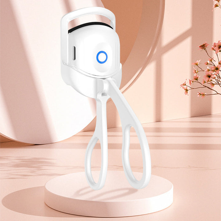 Side view of the heated eyelash curler, showcasing its comfortable grip and modern design for easy use
