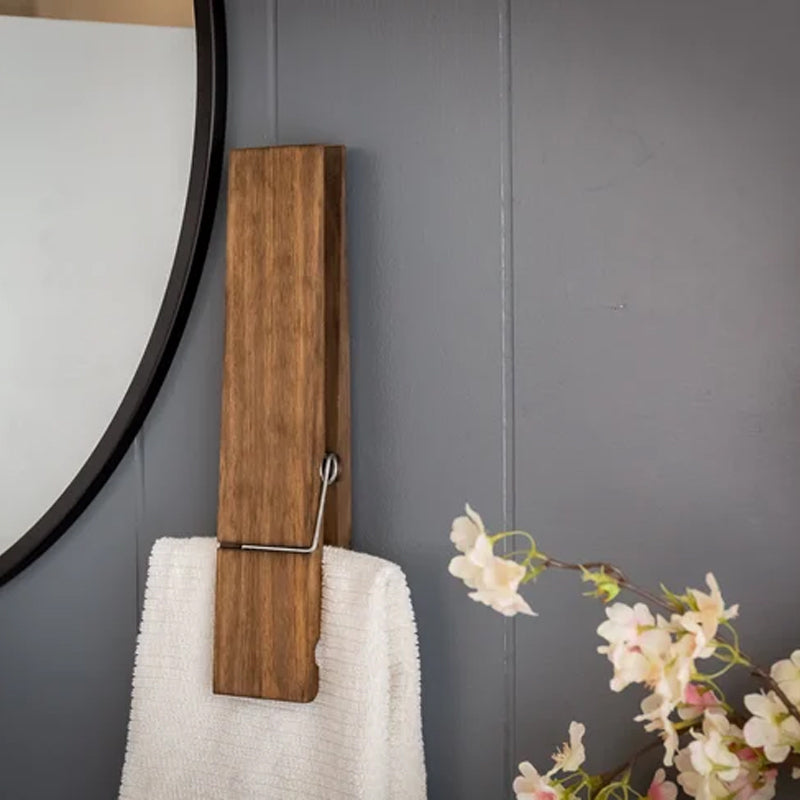 Unique clothespin towel holder, rustic wooden finish, for practical and stylish bathroom storage.