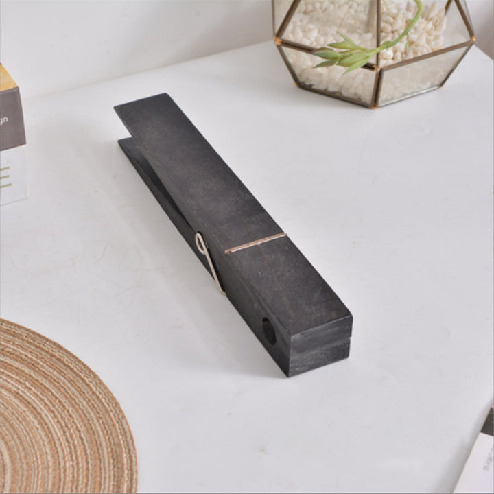 Rustic home organization: wall mounted wooden towel holder with oversized clothespin details.