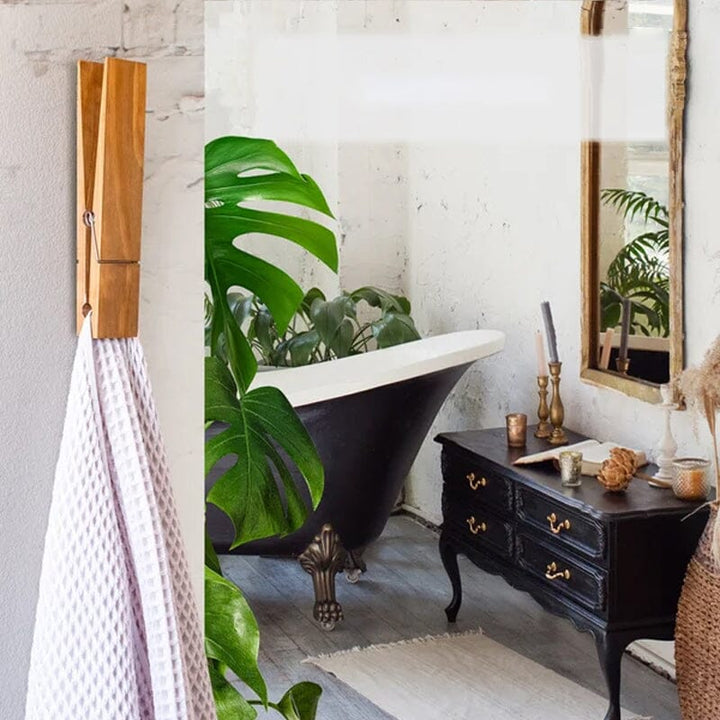 Decorative rustic clothespin towel holder, wall mounted for efficient bathroom space saving.